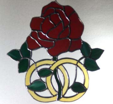 stained glass rose with wedding rings
