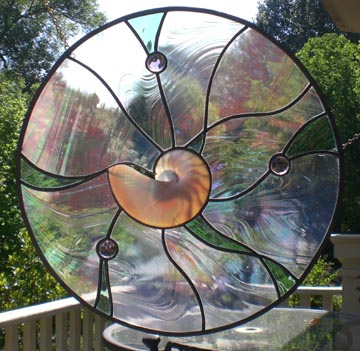 stained glass circle window with shell and jewels using irridecent glass